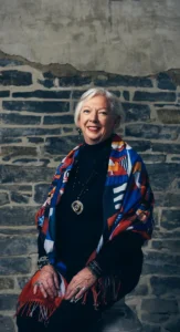 Executive Professional Makeup by Waring Makeup - Ottawa Business Makeup Services Smiling executive woman in a colorful scarf with polished corporate makeup, styled by Waring Makeup, Ottawa Corporate Makeup Artist.