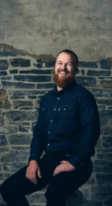 Groomed Executive Makeup by Waring Makeup - Ottawa Business Makeup Services Smiling man in business casual attire with a groomed and polished look, styled by Waring Makeup, Ottawa Office Makeup Services.